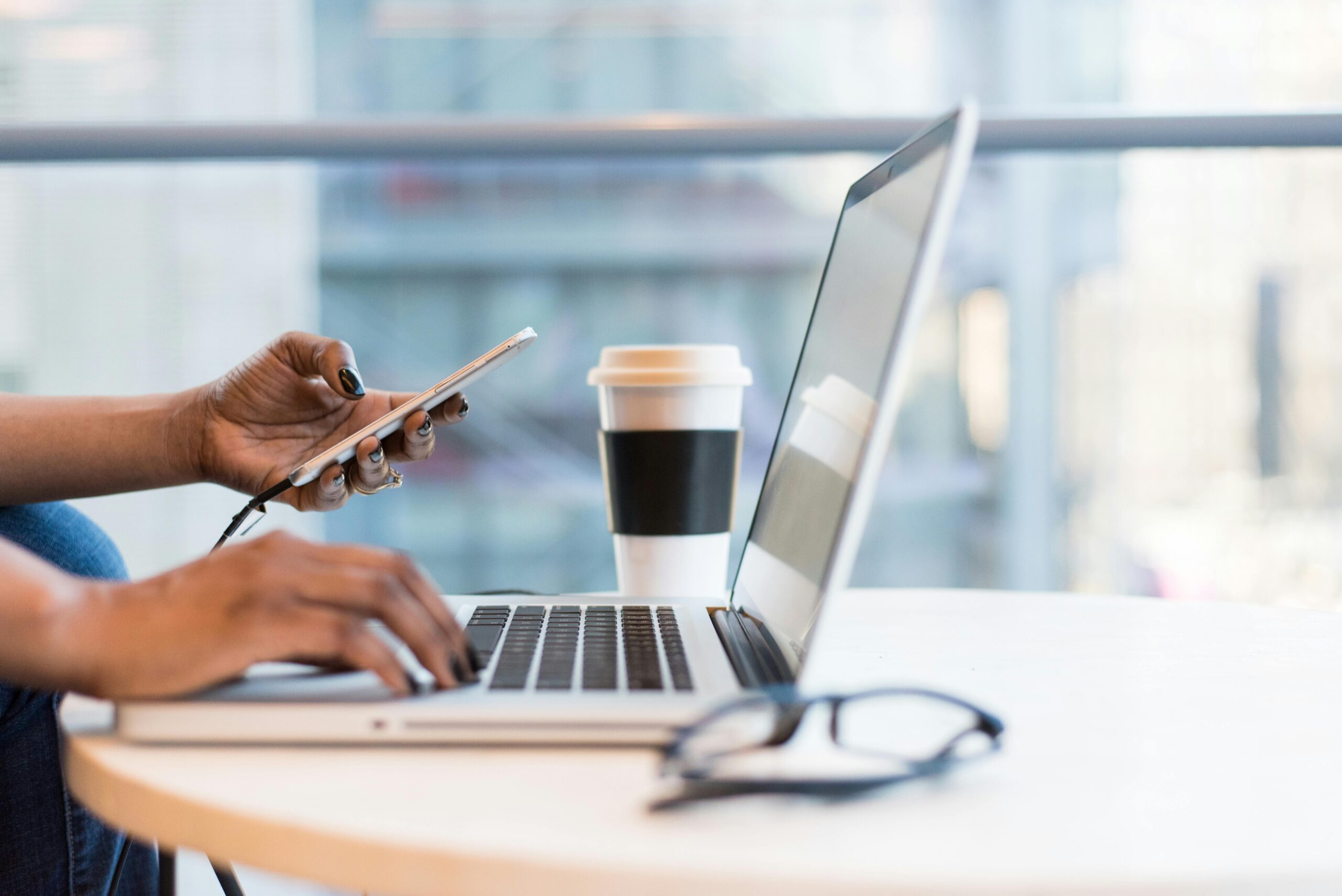 Enhancing-Employee-Performance-with-a-Mobile-Optimized-Workspace-scaledjpg • Managed IT Services and Cybersecurity Provider in Singapore. Free laptop on table top stock photo