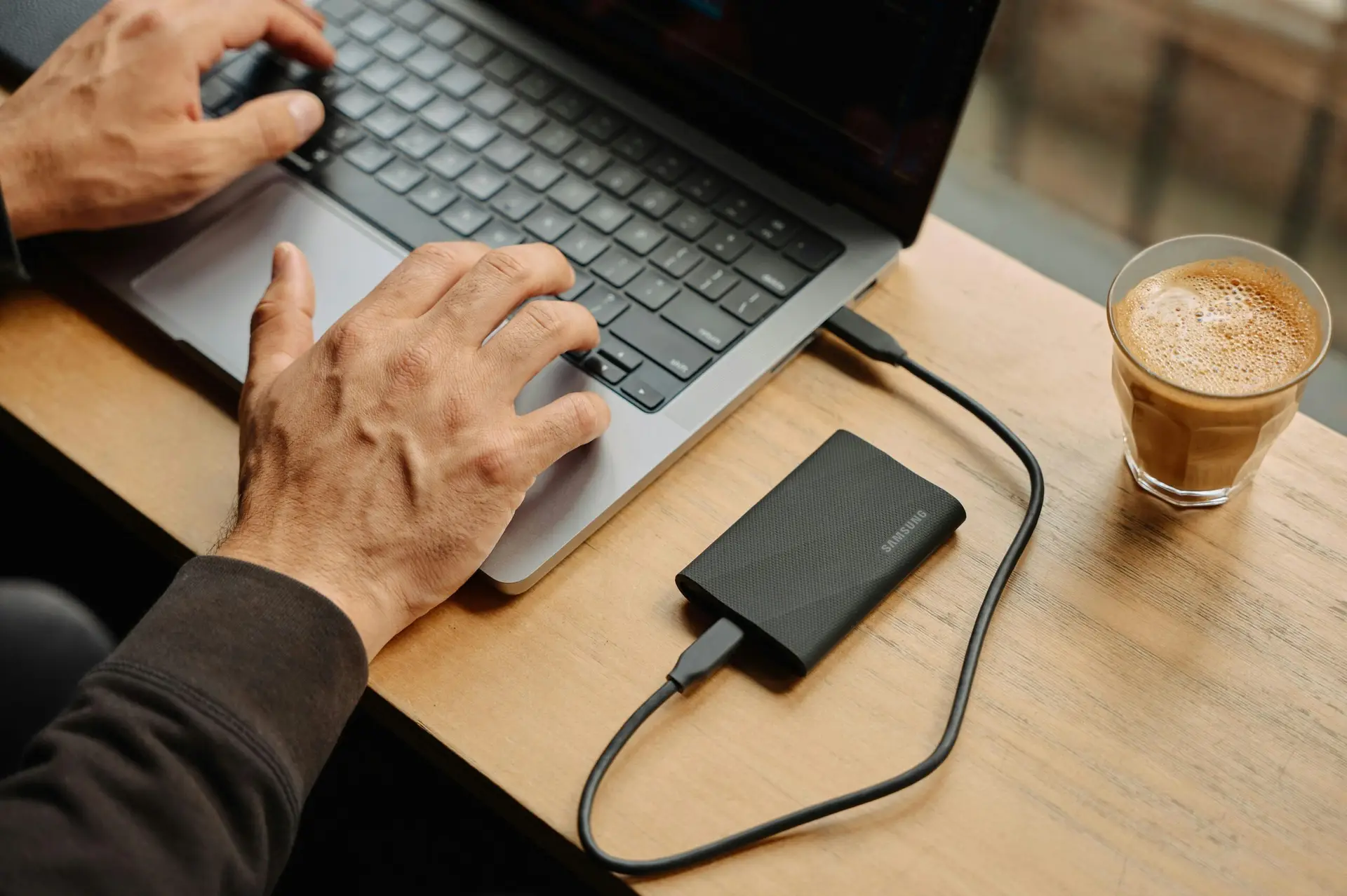 How-Much-Device-Storage-You-Need_-A-Comprehensive-Guide-scaledjpg • Managed IT Services and Cybersecurity Provider in Singapore. A man sitting at a table using a laptop computer