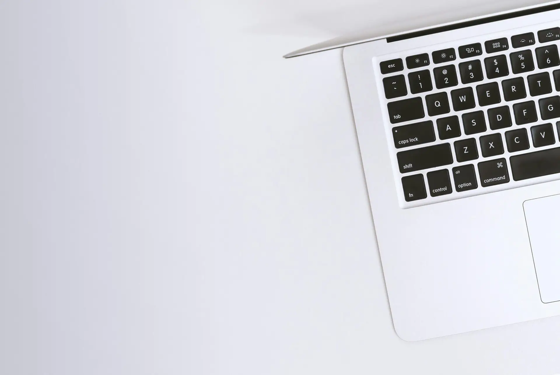 Is-It-Time-For-a-Device-Upgrade_-Check-For-These-7-Signs-scaledjpg • Managed IT Services and Cybersecurity Provider in Singapore. Free Aerial view of a sleek laptop keyboard on a clean, white surface, ideal for tech backgrounds. Stock Photo