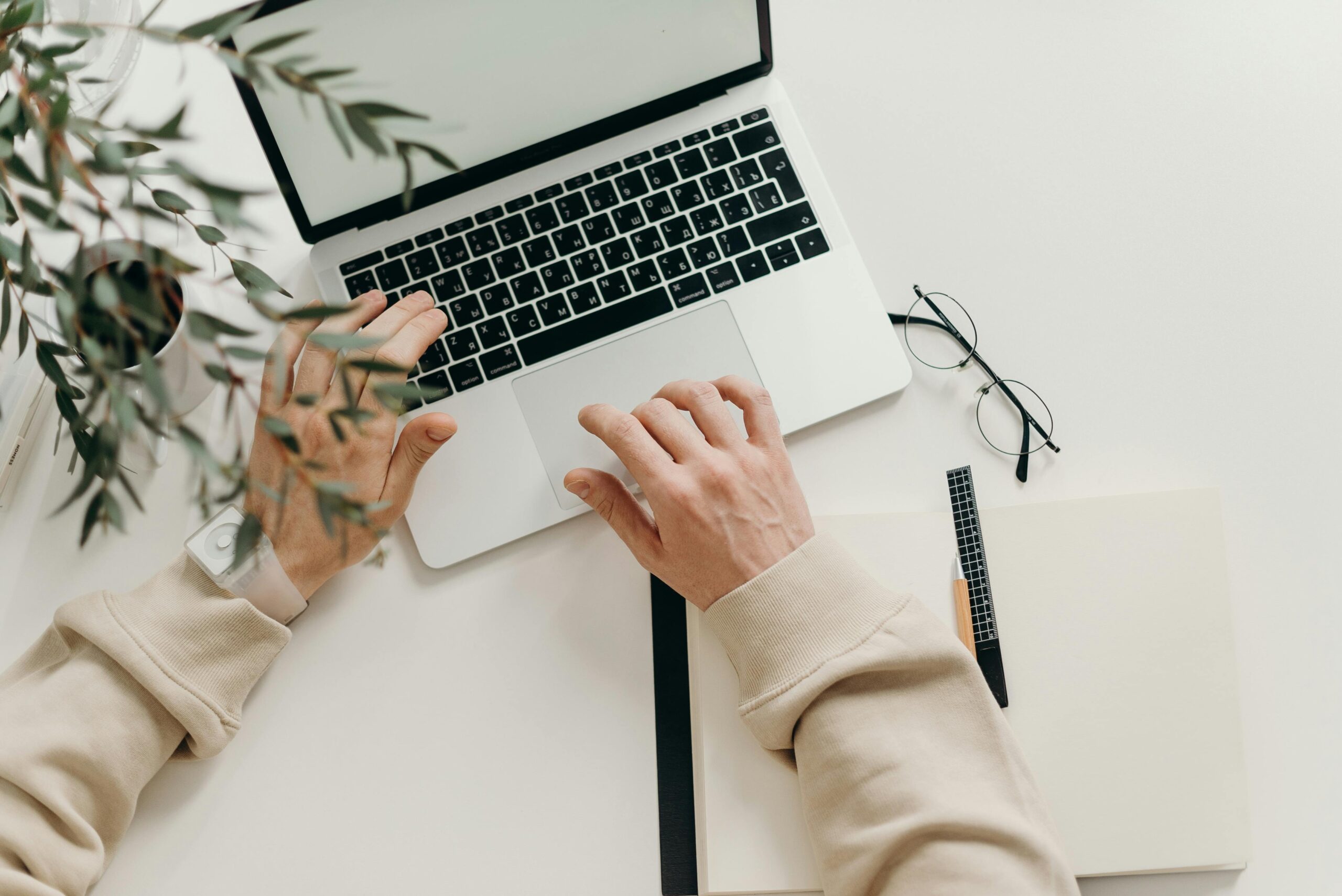 pexels-cottonbro-4065876-scaledjpg • Managed IT Services and Cybersecurity Provider in Singapore. Free An overhead view of a person working on a laptop in a minimalist home office setting. Stock Photo