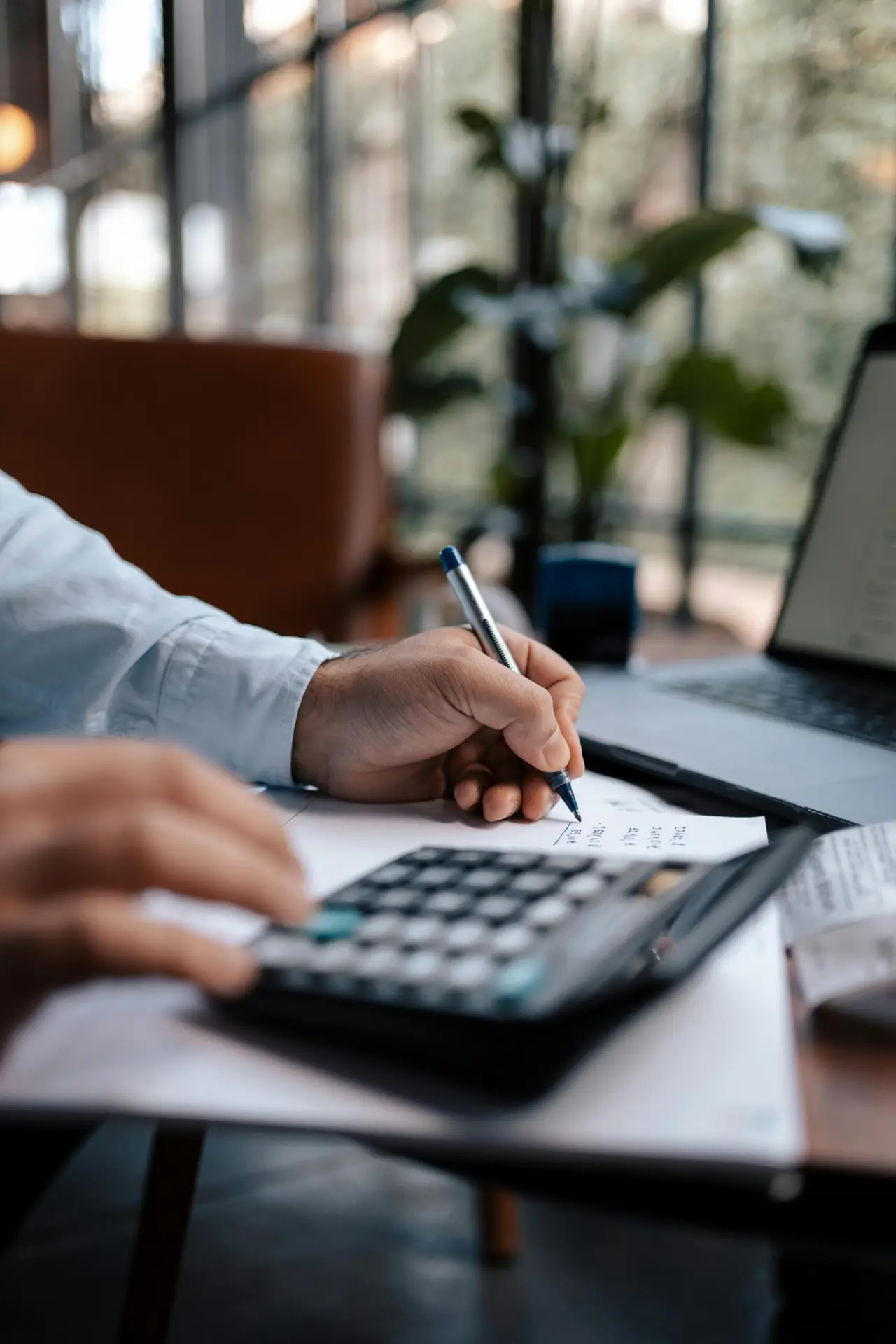 Invest-Smart-Grow-Fast-Your-Small-Business-Guide-to-IT-Expense-Planning-scaledjpg • Managed IT Services and Cybersecurity Provider in Singapore. Free A person calculating finances with a calculator and pen on a desk indoors. Stock Photo