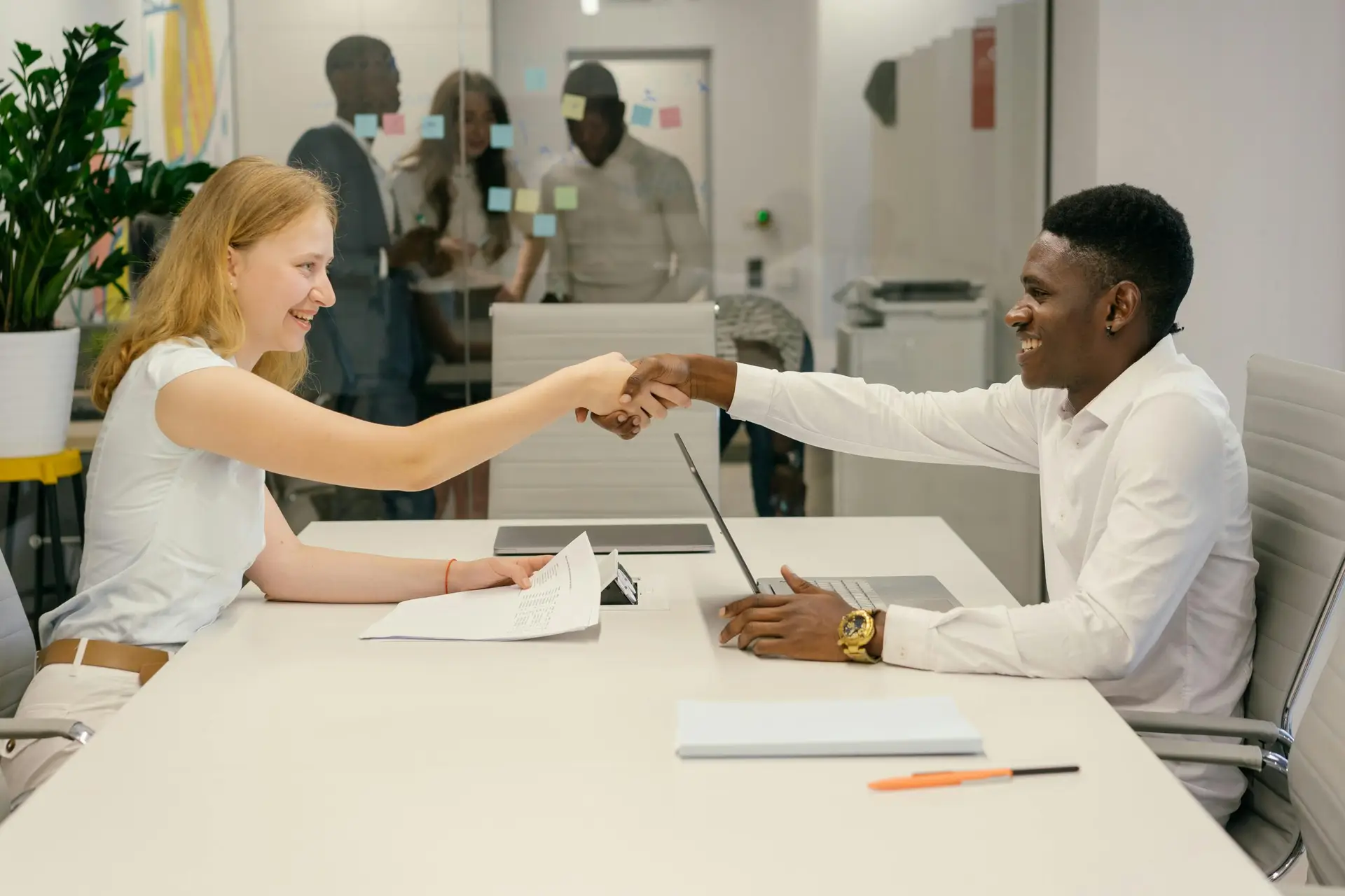 pexels-mikhail-nilov-9301879-scaledjpg | Cybersecurity and Managed Security Services Free Business professionals completing a successful deal with a handshake in a modern office setting. Stock Photo