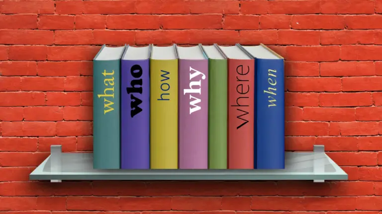 Row of colorful hardcover books on a glass shelf against a red brick wall; vertical spines spell What, Who, How, Why, Where (from left to right).