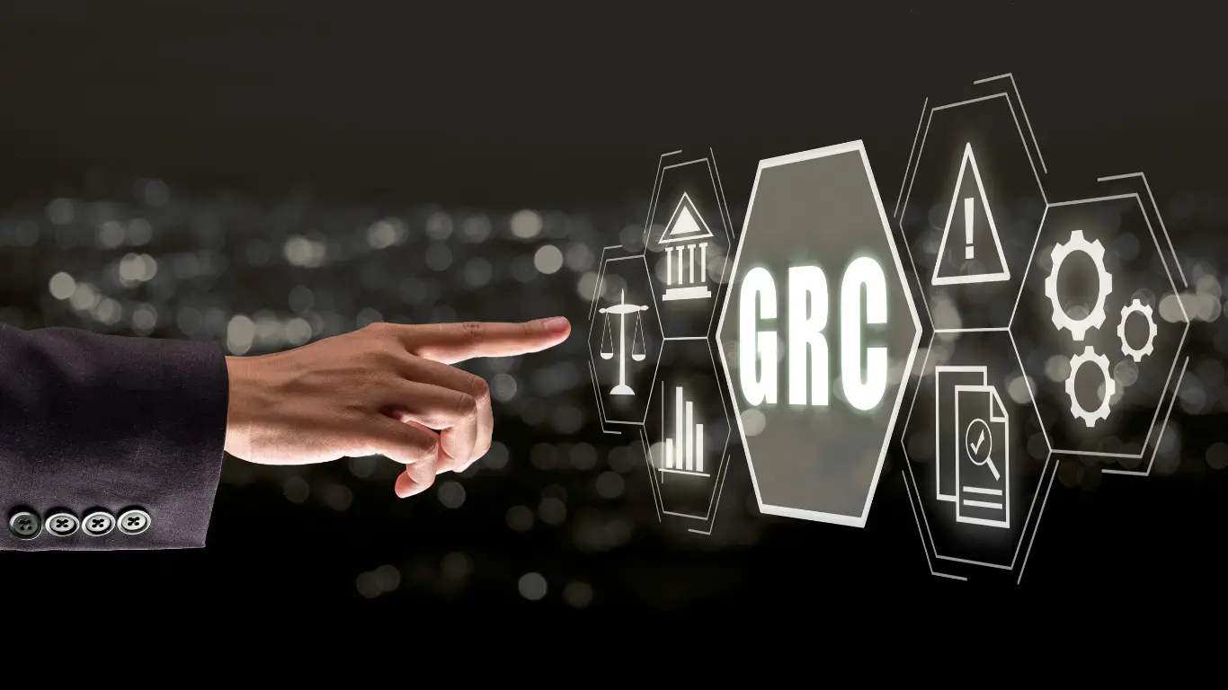 Hand pointing toward a glowing GRC hexagon with governance, risk, and compliance icons.