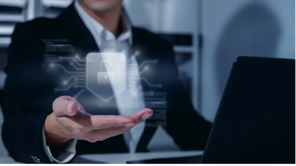 Businessperson in a suit holding out a holographic padlock icon above an open hand, symbolizing cybersecurity.
