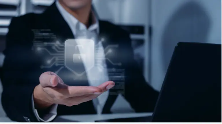 Businessperson in a suit holding out a holographic padlock icon above an open hand, symbolizing cybersecurity.